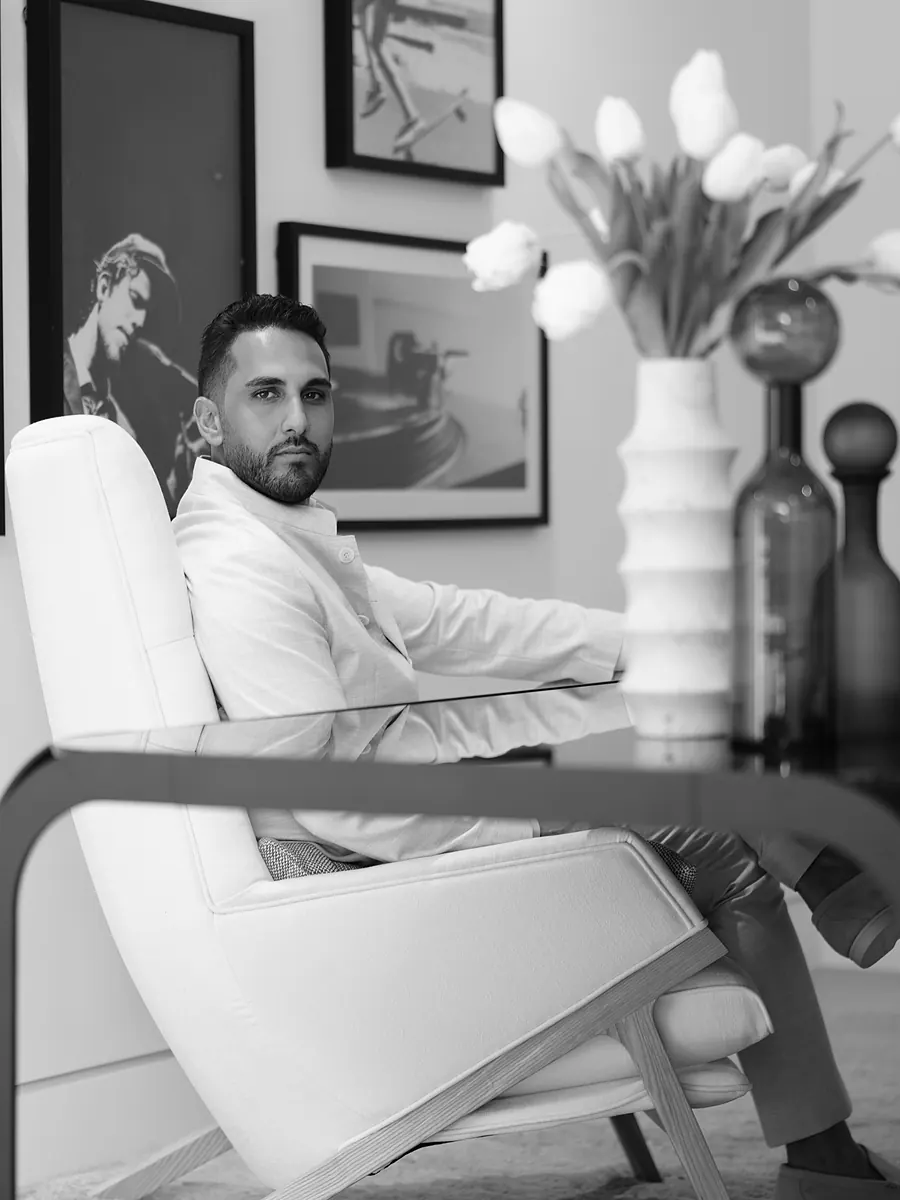Milano, seated in a white armchair, in black and white