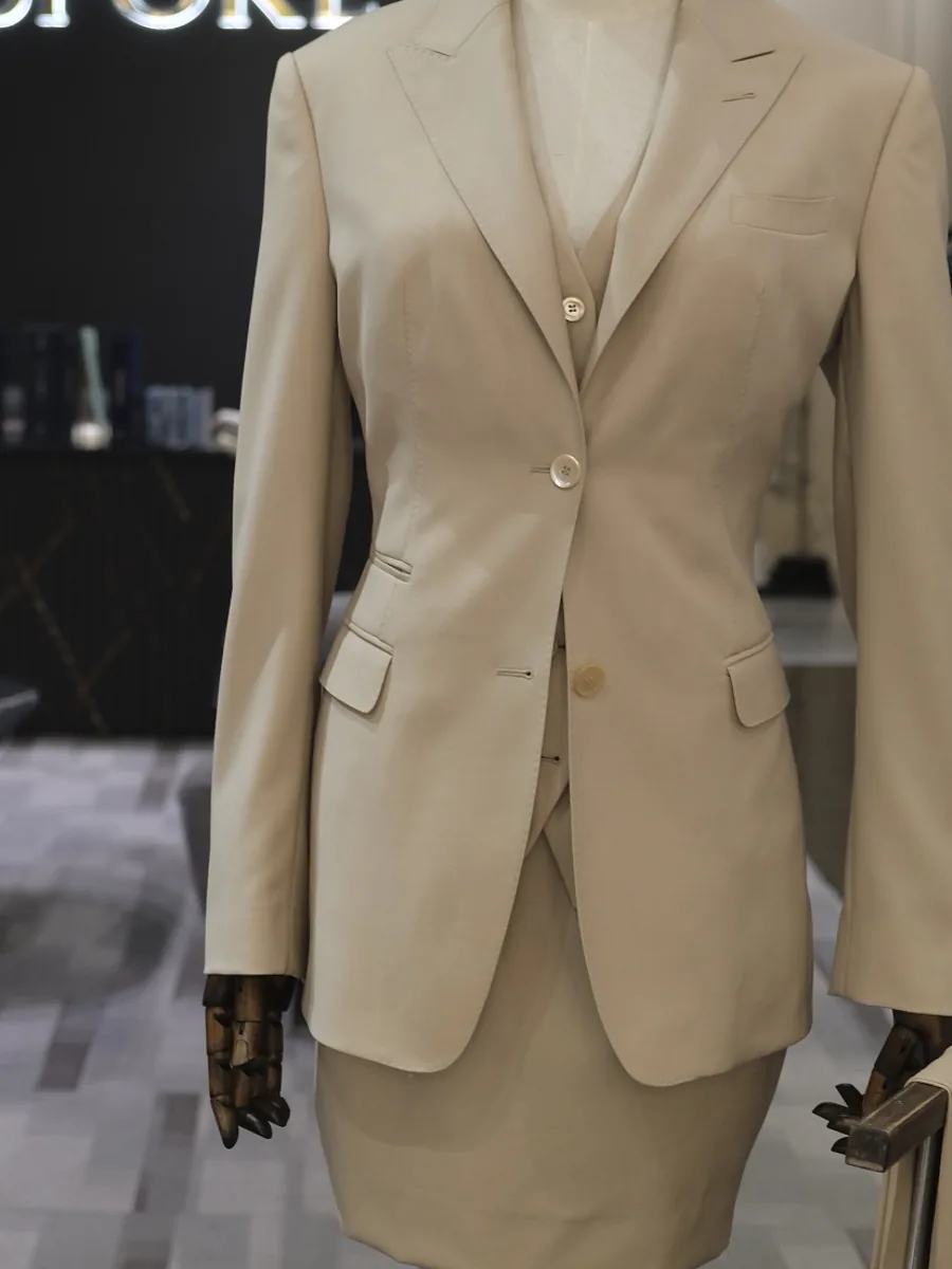Women's camel jacket and skirt, cut and fitted in the showroom